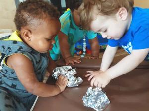 infants exploring aluminum foil