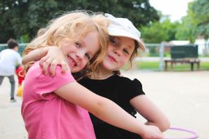 two kinder girls hugging