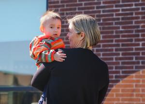 educator holds an infant child