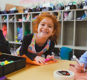 kinder girl smiling brightly