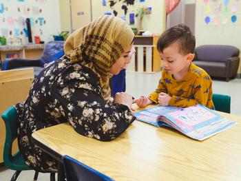 educator reading with a preschooler