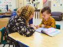 educator reading with a preschooler