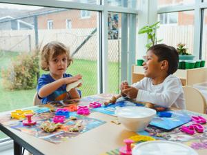 preschool children playing with clay together