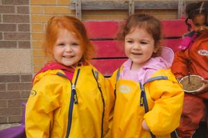 two preschool girls smilint together