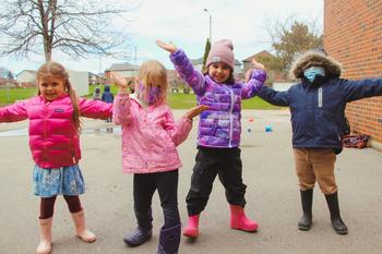 kinder children cheering together outside