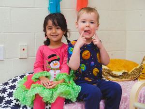 a preschool girl and boy smiling