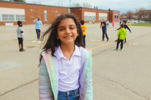school age girl smiling in school yard