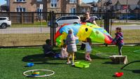 preschoolers playing with a parachute