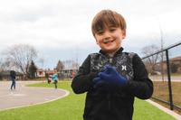 school age boy smiling outside