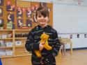 little boy holding a stuffed dog toy