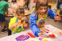 two kinder girls painting with their hands