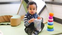 Infant in daycare with toys