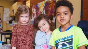 three preschool children smiling