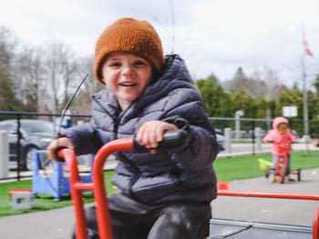 kinder boy laughing while biking