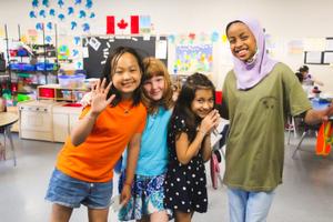 four school age girls laughing together