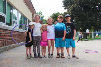 students standing for a picture while playing outside