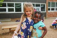 two kinder girls embracing