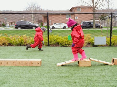children balacing on wooden blocks