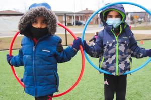 two kinder boys outside with hoola hoops