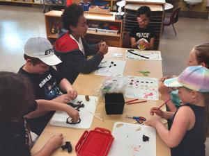 A table of children playing with clay