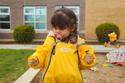 preschool girl admiring dandelines