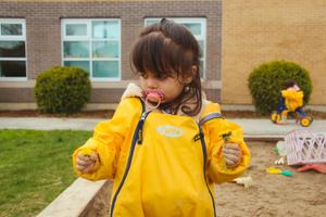 preschool girl admiring dandelines