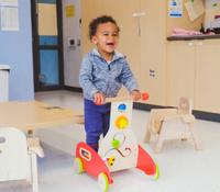 picture of infant child pushing walking toy