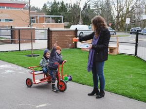 preschool educator and children playing with bubbles