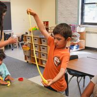 kinder boy playing with slime