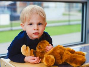 infant with a moose toy