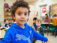 preschool boy smiling with classmates