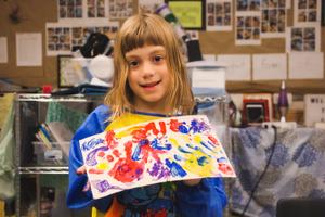kinder girl with her finger painting