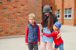 school age children embracing their educator