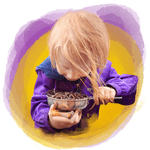 little girl with a bowl of worms
