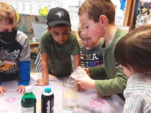 Children experimenting with rain in a jar
