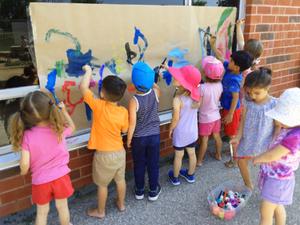 children painting together on one paper