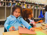 two little girls making paper crafts