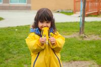 preschool girl smiling with a dandeline
