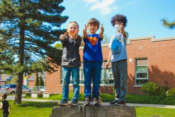 school age boys giving thumbs up