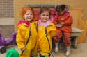 three preschool girls smiling outside