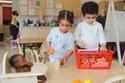 preschoolers playing with toy food