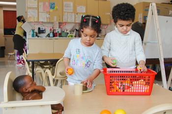 preschoolers playing with toy food