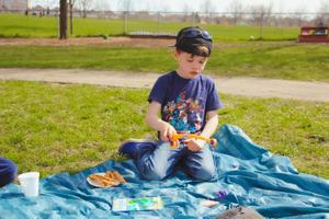 kinder boy playing with a toy fishing set