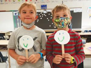 two little boys with plate puppets
